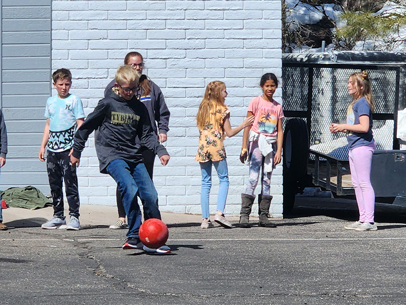 Students playing kickball in the schoolyard