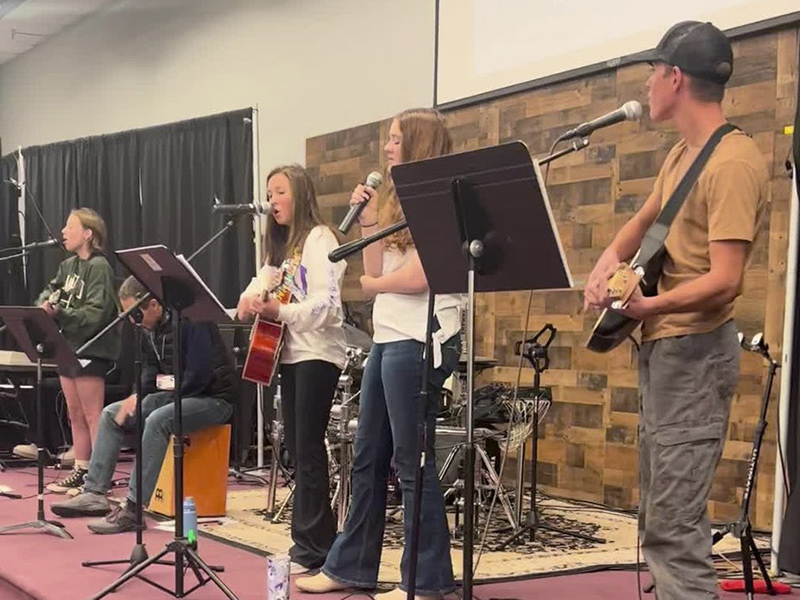 young students playing music in a band on the stage